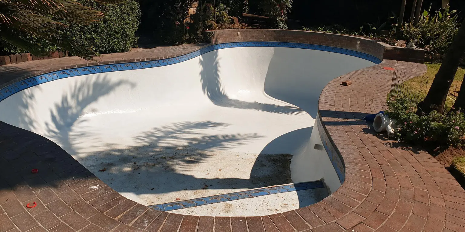 Fibreglass pool surface sanded and prepared for resurfacing