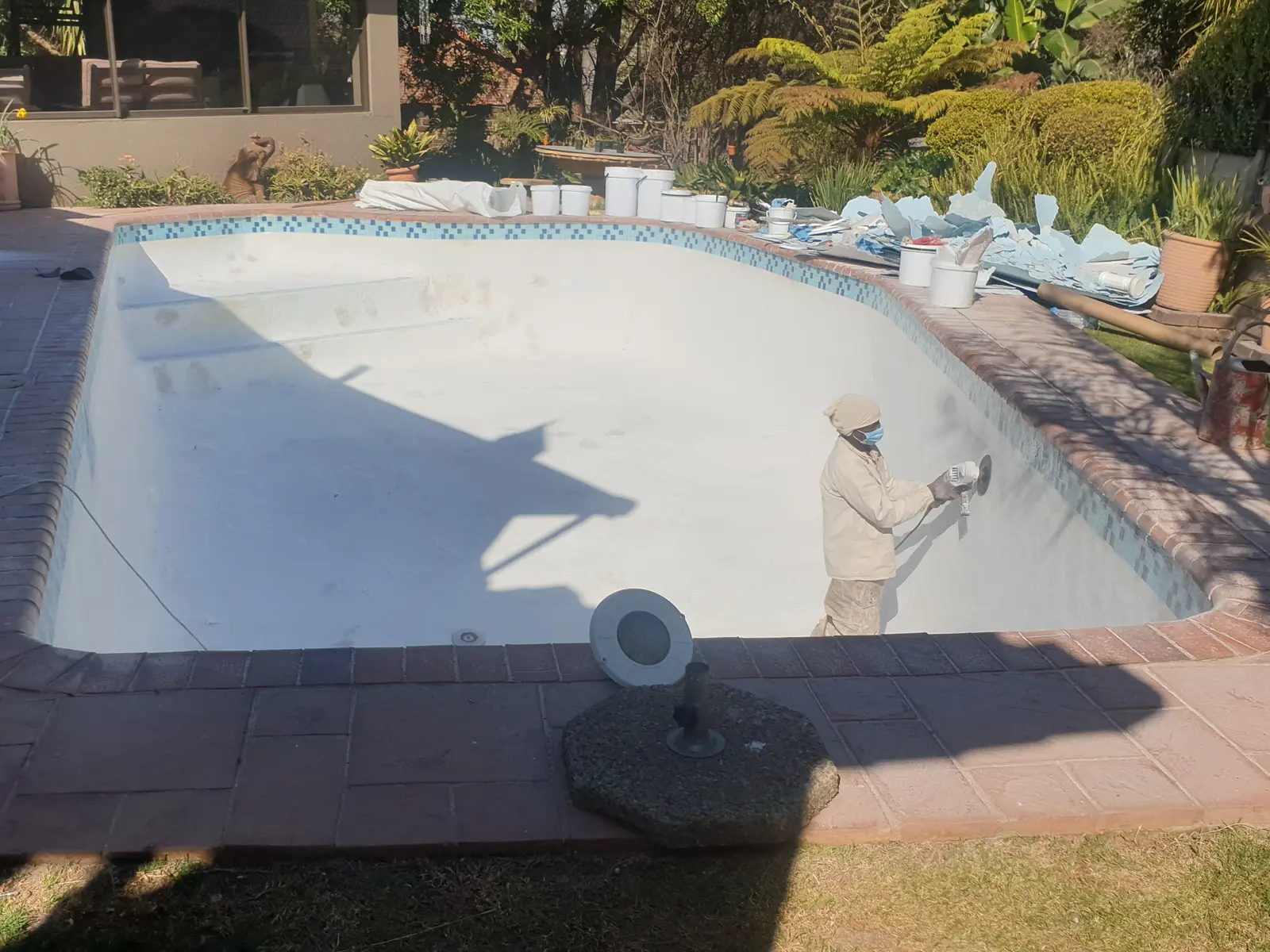 Faded and neglected fibreglass pool before restoration