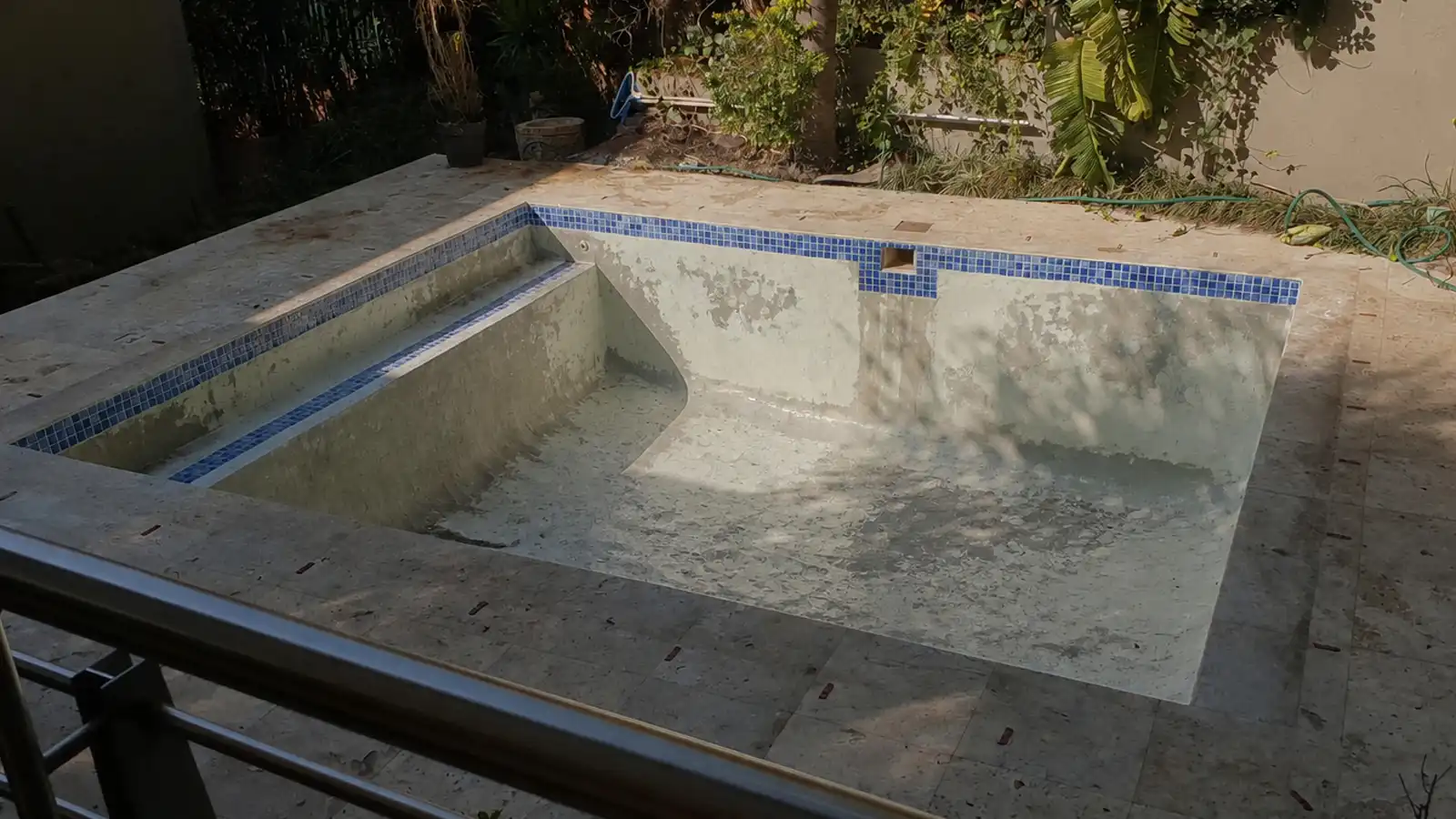 Worn marbelite swimming pool before resurfacing