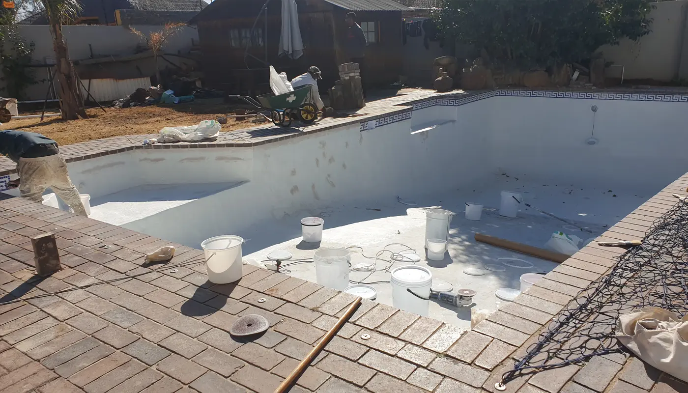 Old Marbelite pool surface being prepared