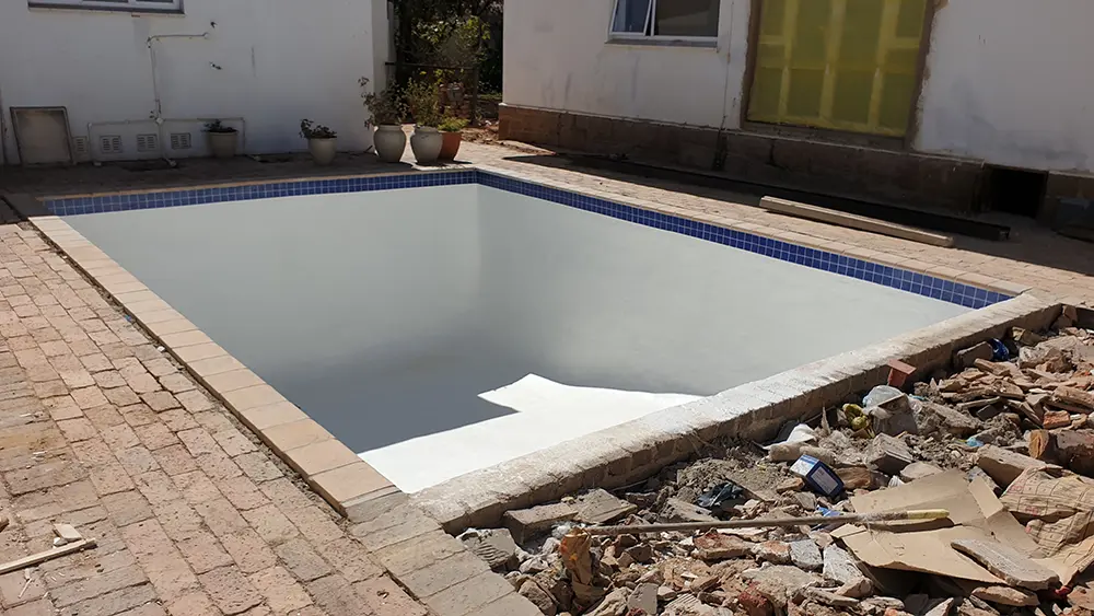 Resized swimming pool after structural renovation and resurfacing