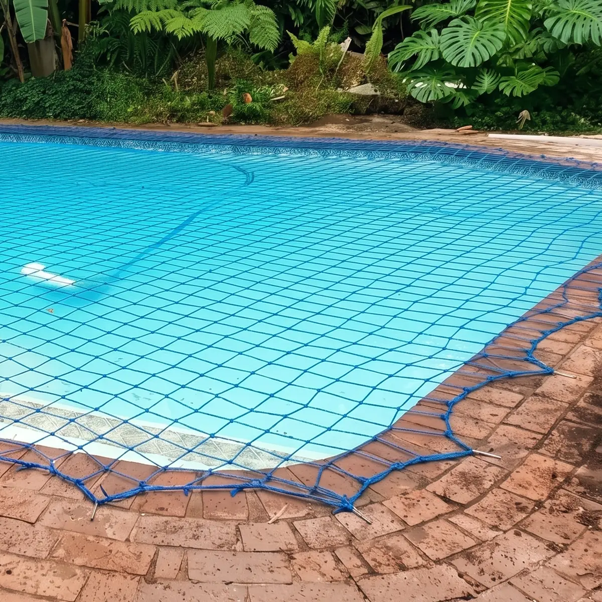 Pool safety net fitted over a residential swimming pool